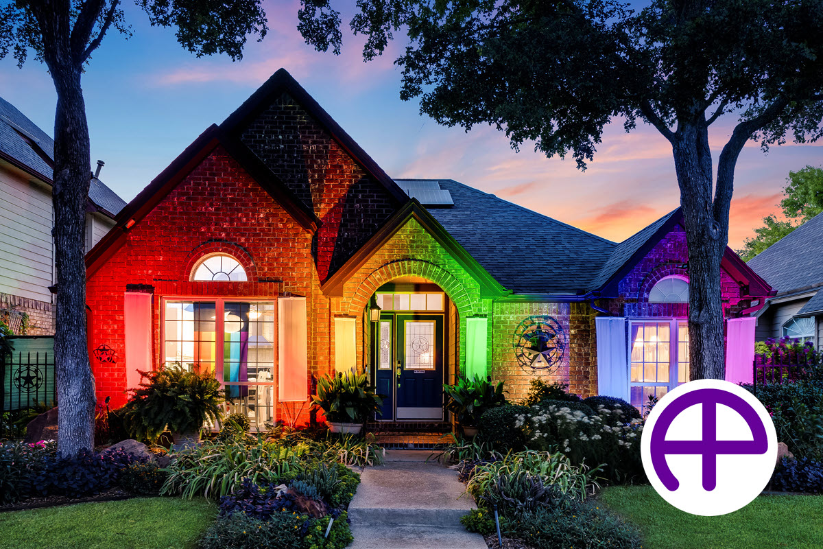 Twilight photo of a pride home in irving, texas, adorned with a rainbow of colored lights, captured by accuphotography