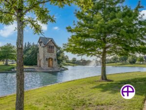 Photo of community amenities with pond, fountain, and stone tower enhanced by accuskyreplacements™ service