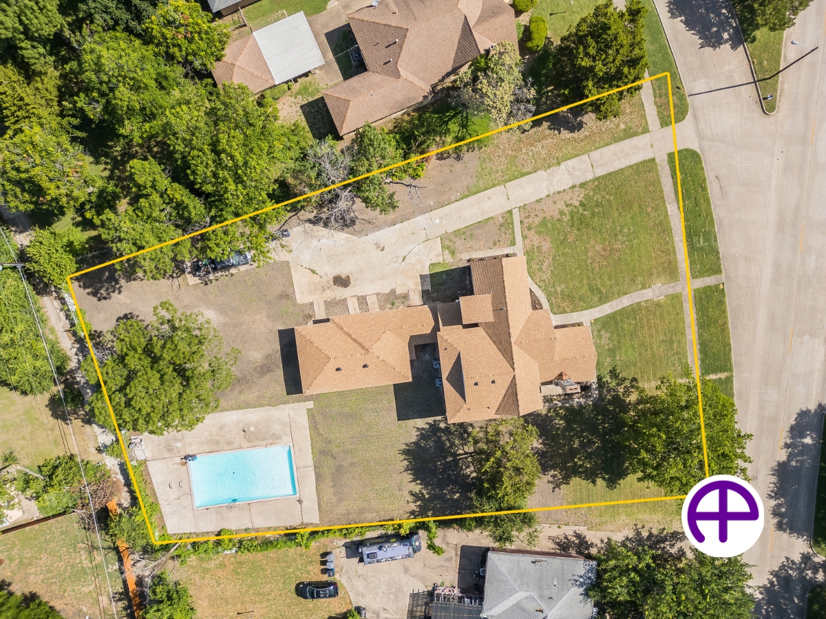Aerial view of property with outdoor inground pool in dallas, texas, highlighting property boundaries