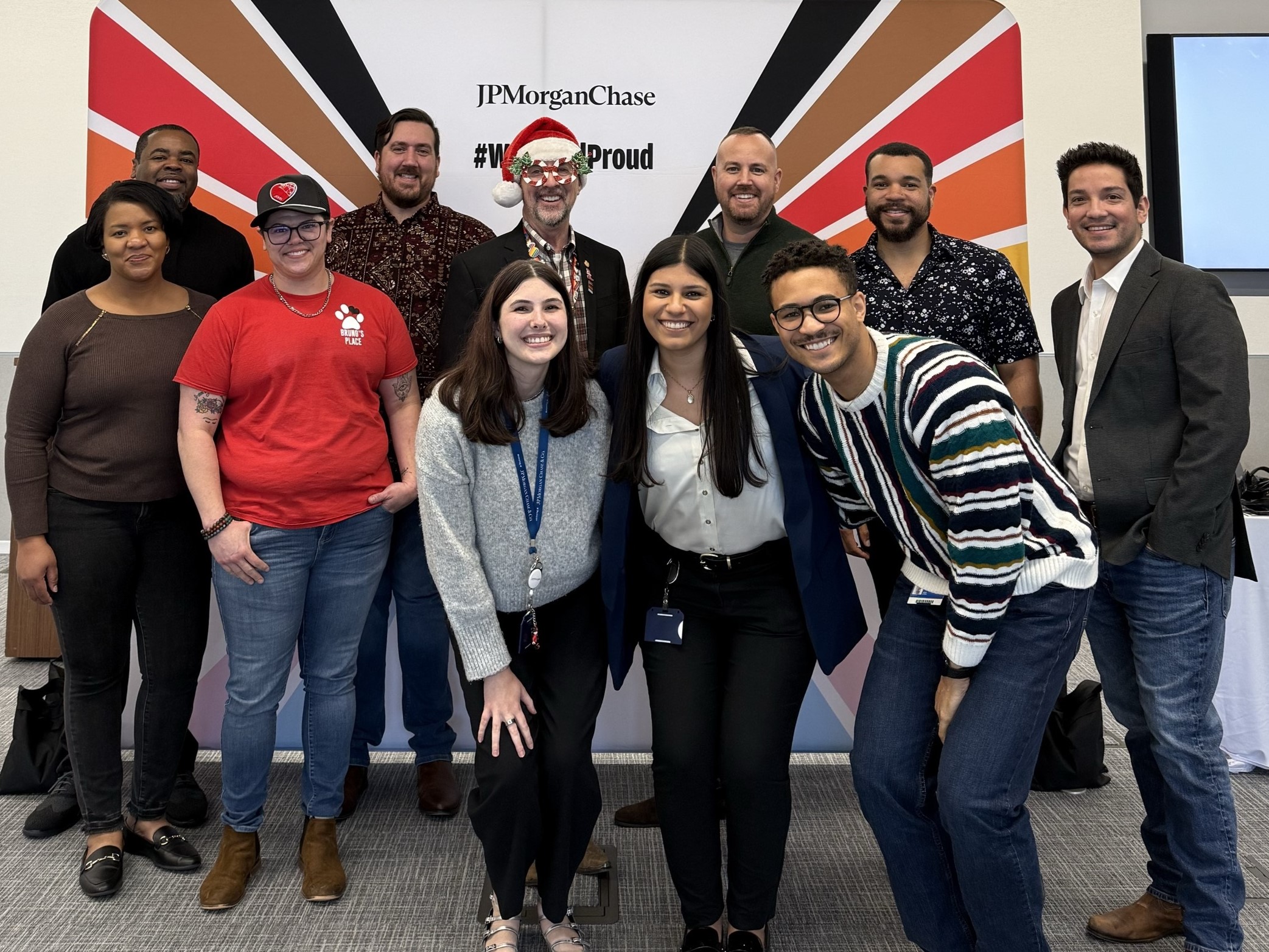 Jpmorgan Chase Pride Showcase Group Photo In Plano Group photo of participants at the jpmorgan chase pride showcase in plano in front of the #westandproud backdrop, organized by the chase lgbtq+ employee resource group.