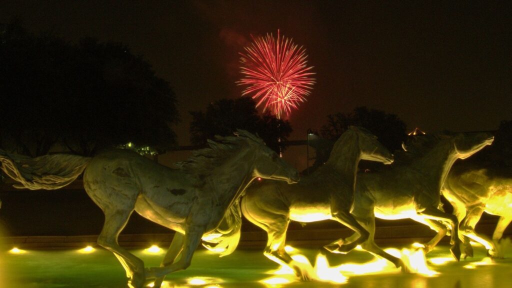 Photo of the iconic mustangs at williams square in las colinas, irving, texas, on the 4th of july, showcasing the vibrant dfw area served by acculocations.