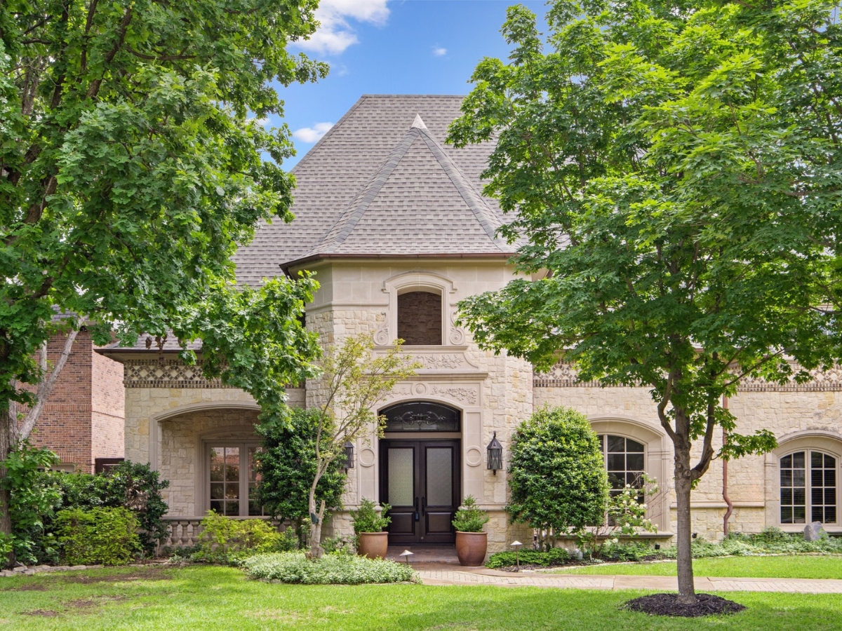 Two-story luxury residential home in Dallas, Texas, enhanced with AccuSkyReplacement for vibrant blue skies.