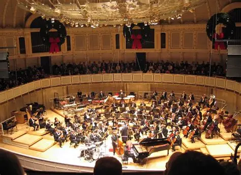 Chicago symphony orchestra is performing live on stage inside chicago's symphony hall.